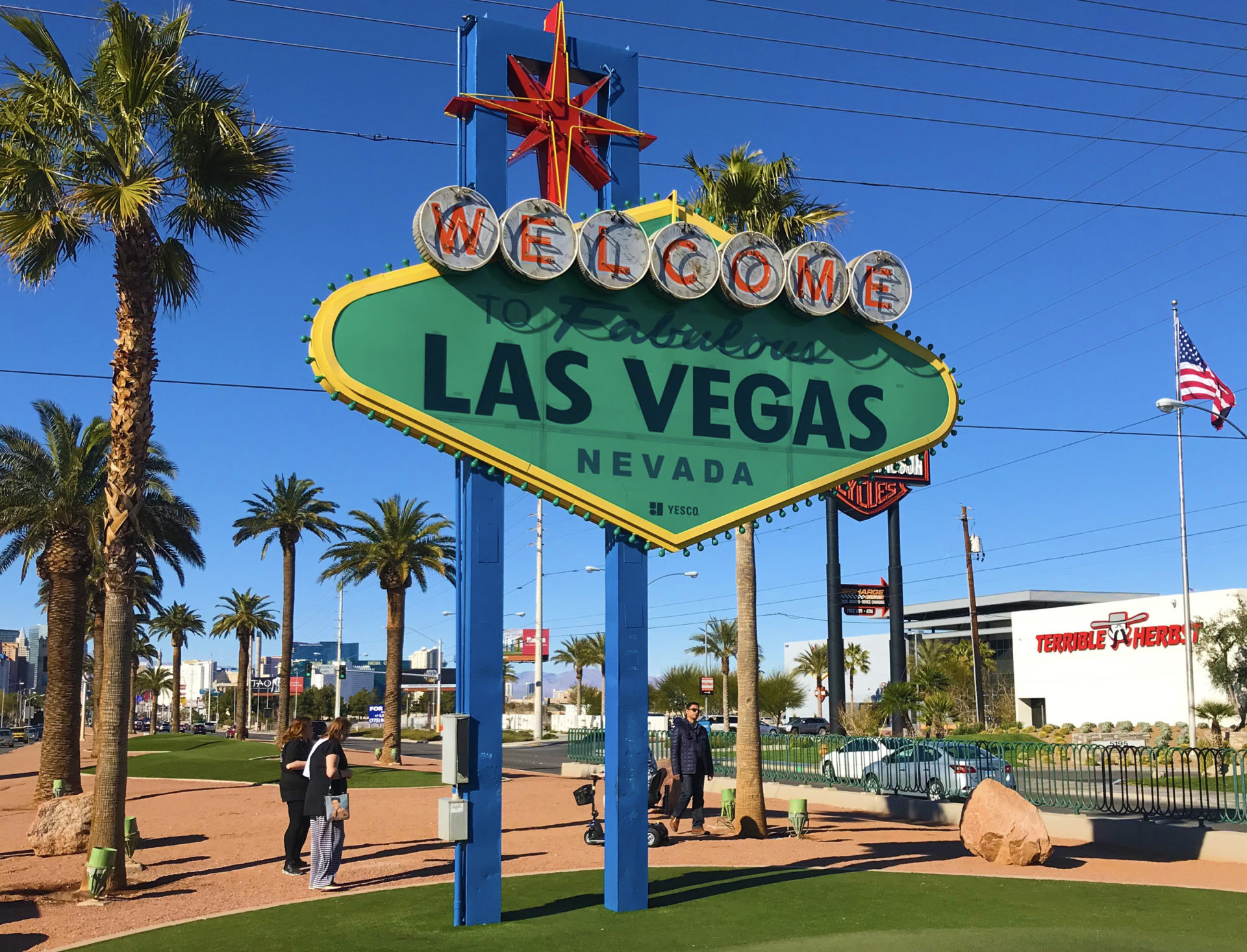 The iconic Welcome to Las Vegas sign features bold, neon-lit lettering set placed in Paradise, Nevada where palm trees surrounded the sign