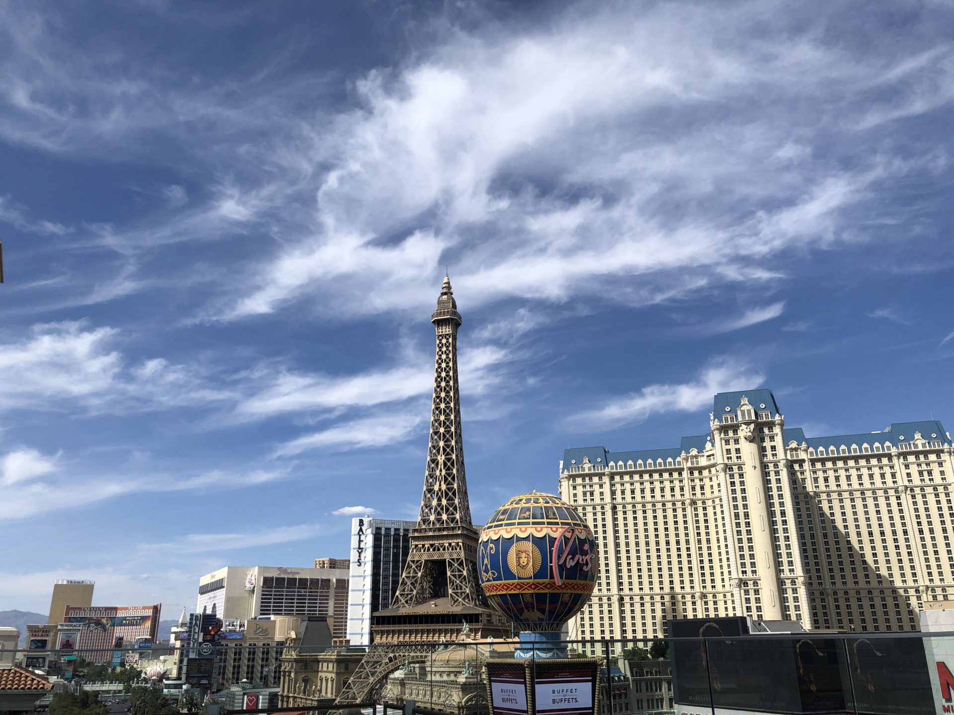 The Las Vegas Eiffel Tower stands as a replica of its original french counterpart, featuring intricate ironwork illuminated by vibrant lights, offering a stunning and iconic landmark on the glittering Strip.