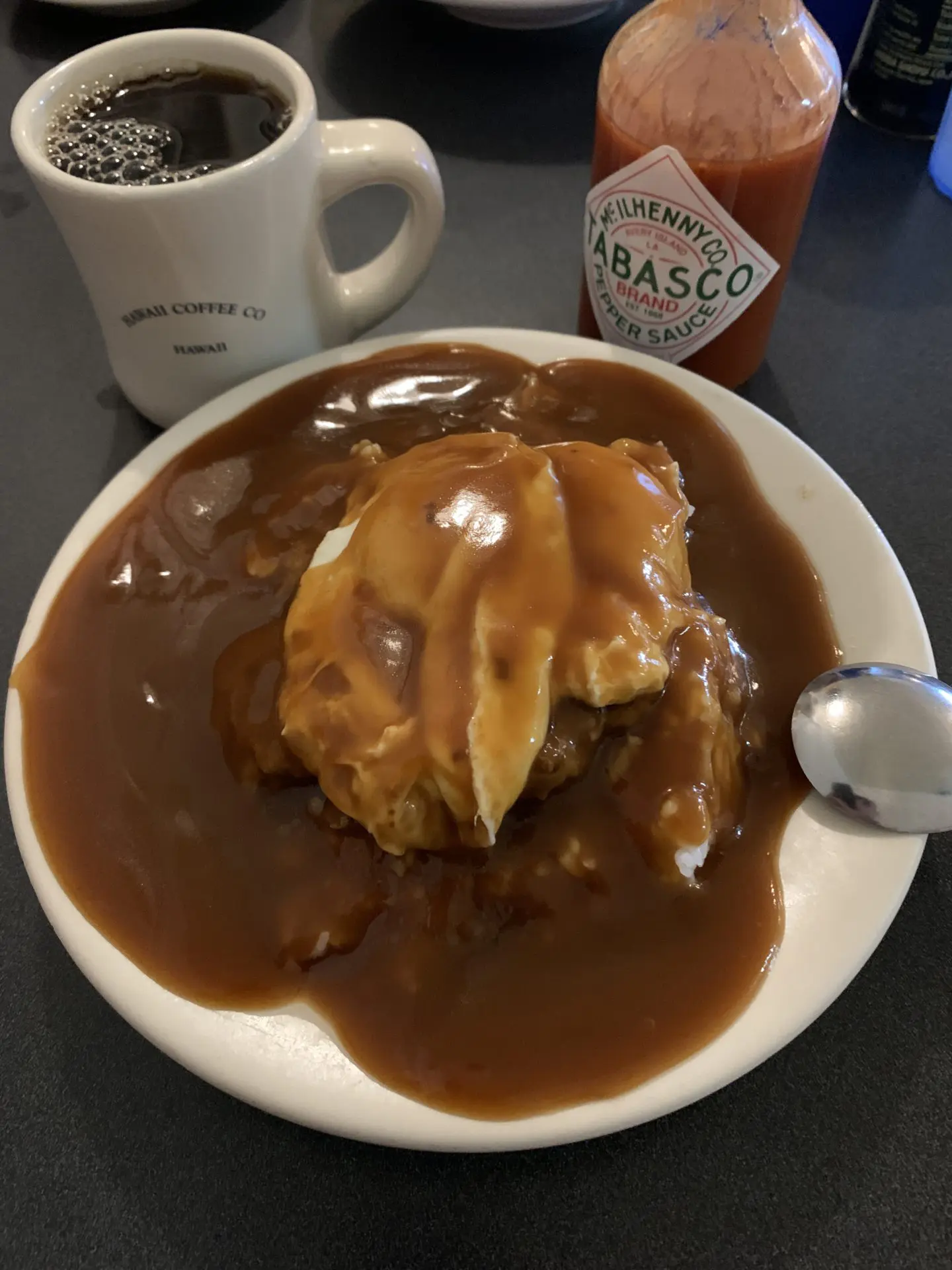 Tip Top Cafe putting a gracious amount of gravy on a Loco Moco