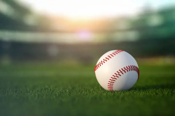 Close-up of a baseball with the Las Vegas Athletics logo, resting on a field of green grass, highlighting the team's identity and sport