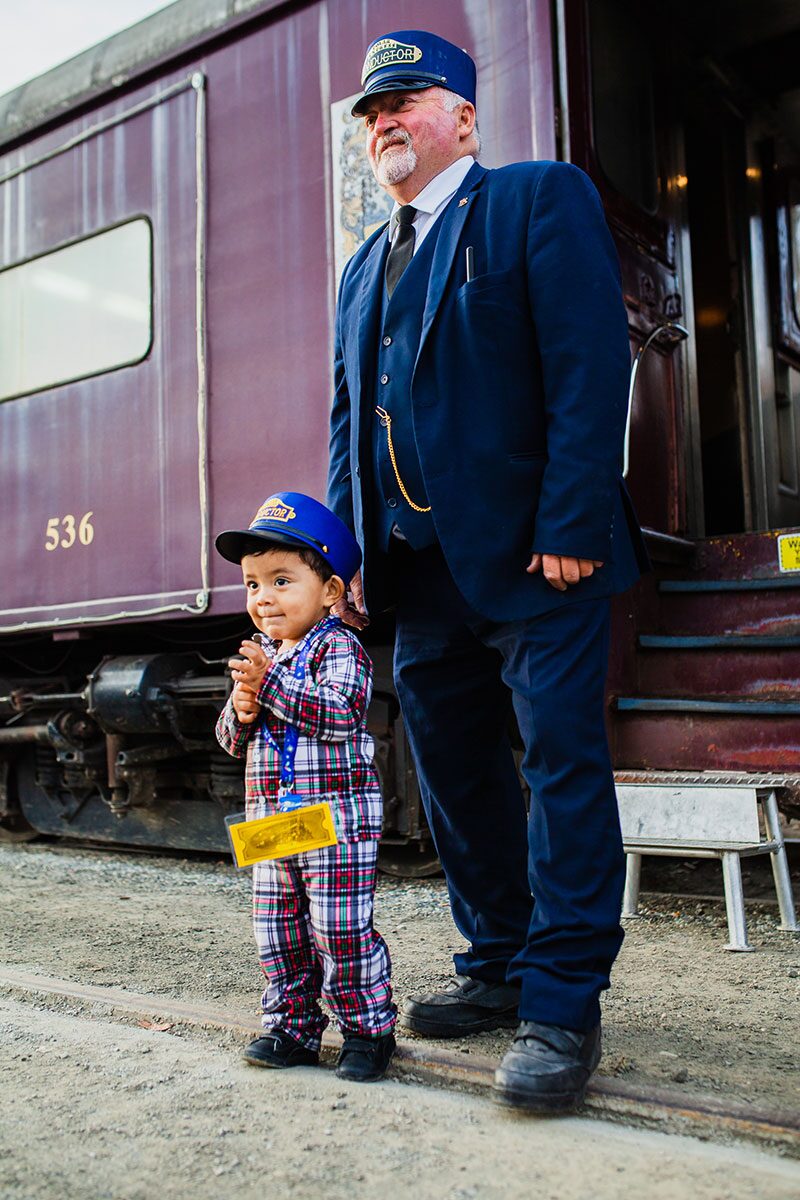 polar express train conductor with a child